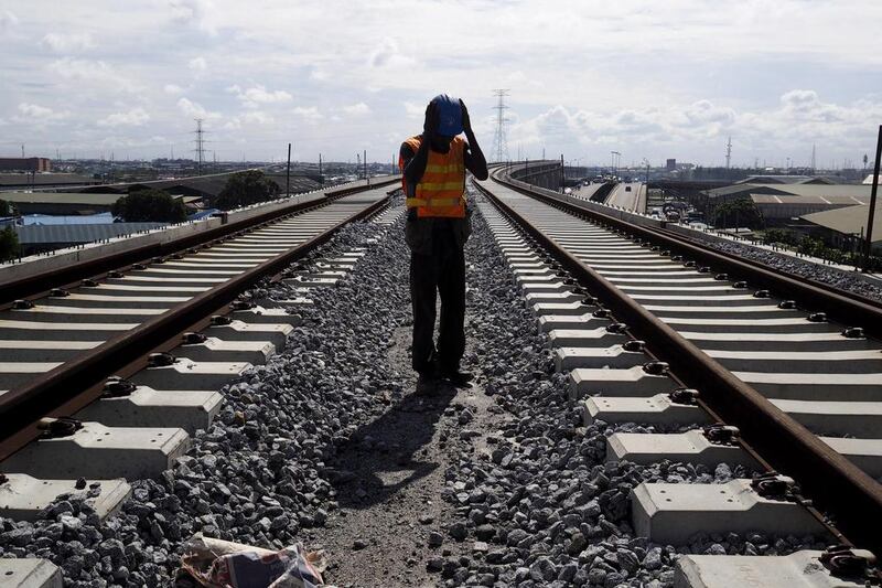 A man works on a train track of the Blue Line of the light rail system under construction in Lagos, Nigeria. The Blue Line costs $1.2 billion and is funded entirely by the Lagos state government. Joe Penney / Reuters