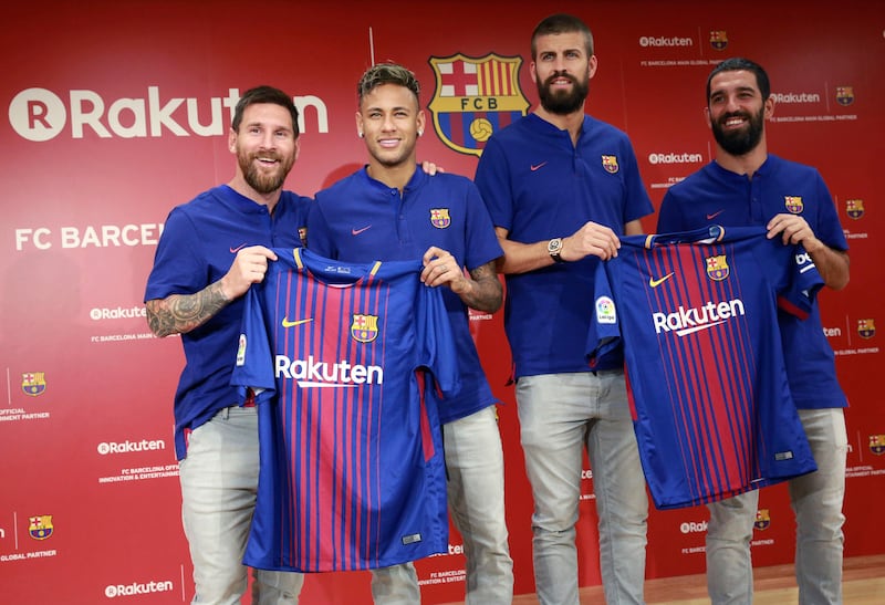 From left, FC Barcelona's Lionel Messi, Neymar, Gerard Pique and Arda Turan pose with their new jerseys during a press conference in Tokyo Thursday, July 13, 2017. They are in the city to introduce Japanese online retailer Rakuten as the main global sponsor of the soccer club. (AP Photo/Eugene Hoshiko)