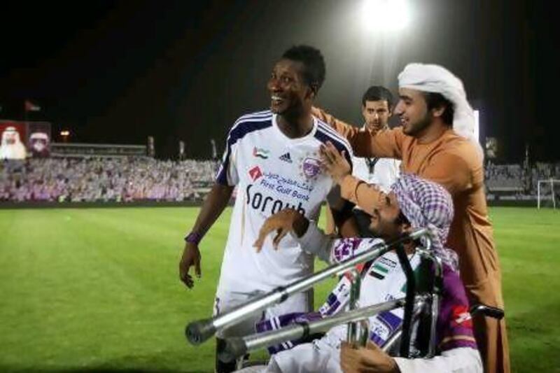 Asamoah Gyan shares in the celebration spirit with Al Ain fans after the final league match.