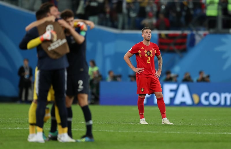 Belgium's Toby Alderweireld looks on while France celebrate their win. Getty Images