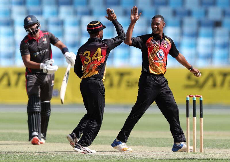 PNG's Alei Nao takes the wicket of UAE's Muhammad Waseem. Chris Whiteoak / The National