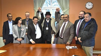 Representatives from the Yemeni government delegation, right, and the Houthi rebels, pose for a photo with negotiators. AFP