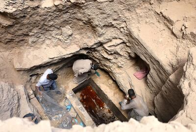 Archaeologists unearth coffin containing three mummies with sewage water and bones inside, in Alexandria, Egypt July 19, 2018. REUTERS/Mohamed Abd El Ghany