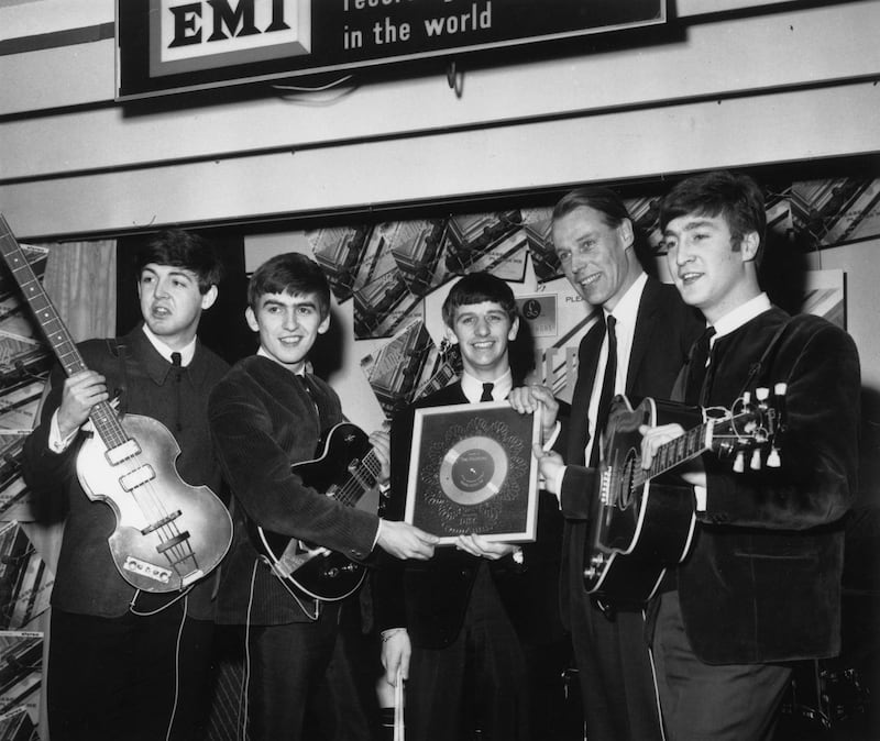 8th April 1963:  British pop group The Beatles holding their silver disc. Left to right are, Paul McCartney, George Harrison (1943 - 2001), Ringo Starr, George Martin of EMI and John Lennon (1940 - 1980).  (Photo by Chris Ware/Keystone/Getty Images)