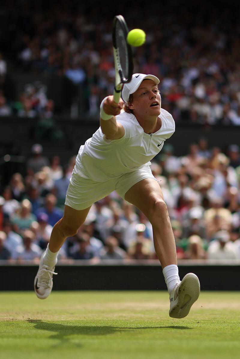 Jannik Sinner plays a forehand against Novak Djokovic. Getty 