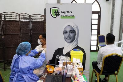 People receiving Covid 19 vaccine shots at the Ajman Society of Social & Cultural Development in Ajman, UAE.  Pawan Singh/The National. 
