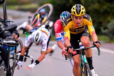 French Julian Alaphilippe (back) of Deceuninck - Quick-Step falls after touching a motorcyclist, as he rides behind Belgian Wout Van Aert of Team Jumbo-Visma and Dutch Mathieu van der Poel of Alpecin-Fenix during the 'Ronde van Vlaanderen or Tour of Flanders' one day cycling race, 241 km from Antwerp to Oudenaarde on October 18, 2020. Belgium OUT / AFP / BELGA / Belga / Luc CLAESSEN