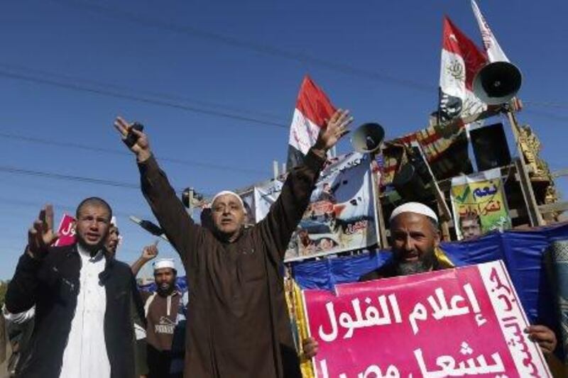 Islamist protesters supporting Egyptian president Mohammed Morsi outside the Media City complex in Giza. Their sign reads "journalist remnants will destroy Egypt”.