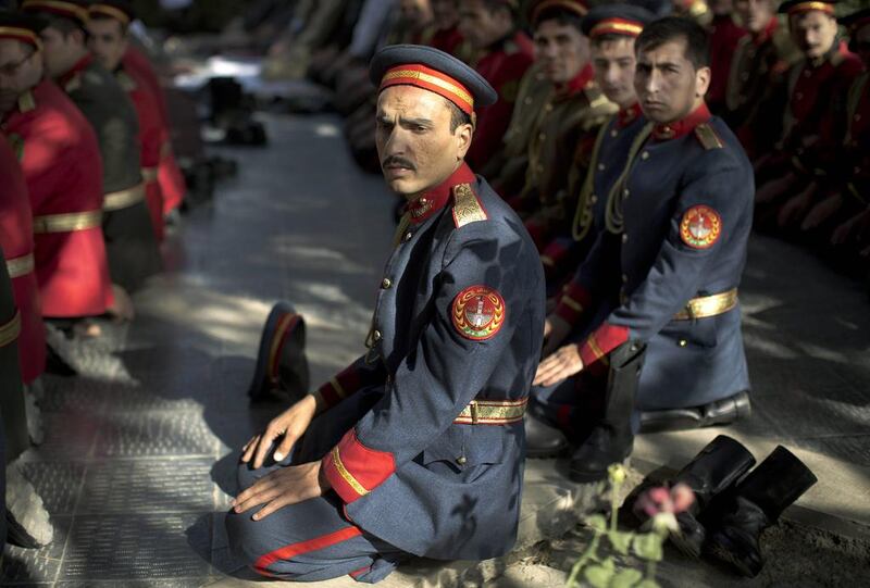 Members of the Afghan honour guard perform Eid Al Adha prayers outside a mosque at the Presidential Palace in Kabul.