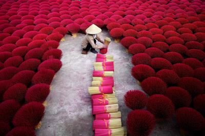 - AFP PICTURES OF THE YEAR 2019 - 

This picture taken on January 3, 2019 shows a Vietnamese woman collecting incense sticks in a courtyard in the village of Quang Phu Cau on the outskirts of Hanoi. In Vietnam's 'incense village', hundreds of workers are hard at work dying, drying and whittling down bamboo bark to make the fragrant sticks ahead of the busy lunar new year holiday. - 
 / AFP / Manan VATSYAYANA
