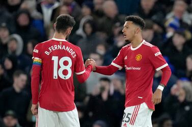 Manchester United's Jadon Sancho celebrates with Bruno Fernandes, left, after scoring the opening goal during the English Premier League soccer match between Chelsea and Manchester United at Stamford Bridge stadium in London, Sunday, Nov.  28, 2021.  (AP Photo / Kirsty Wigglesworth)