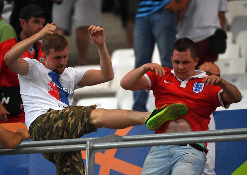 A Russia supporter, left, clashes with an England supporter in the stands during the UEFA EURO 2016 group B preliminary round match between England and Russia at Stade Velodrome in Marseille, France. Peter Powell / EPA
