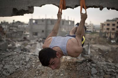 Mahmoud Nasman of team Bar Palestine trains amid rubble in Gaza city.