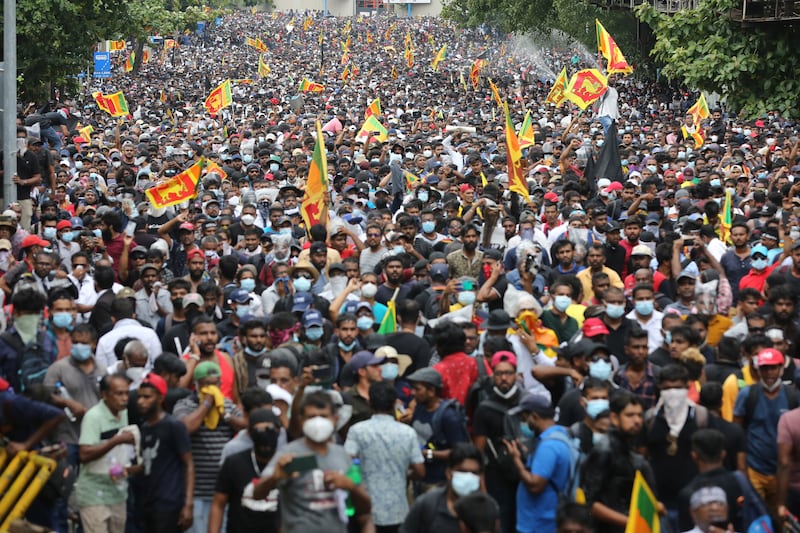 People attend an anti-government protest rally near the President's house in Colombo earlier in July. EPA