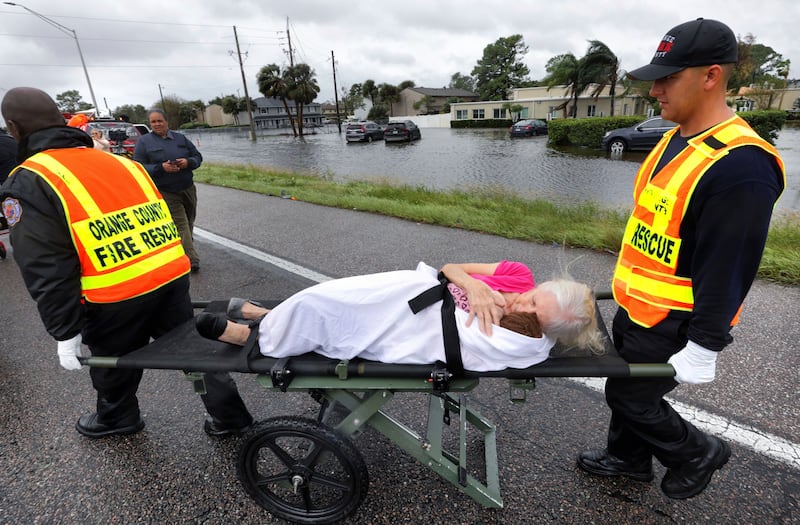 An Avante at Orlando resident is taken to safety. AP