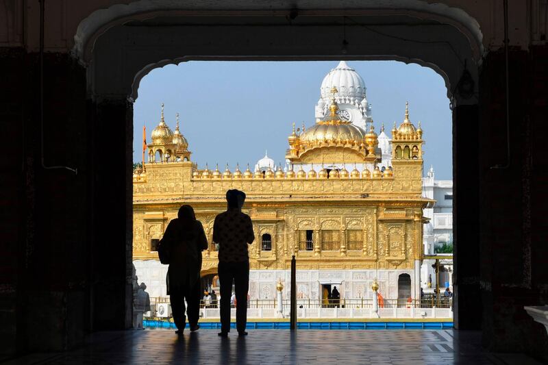 A couple enters the Golden Temple complex. AFP