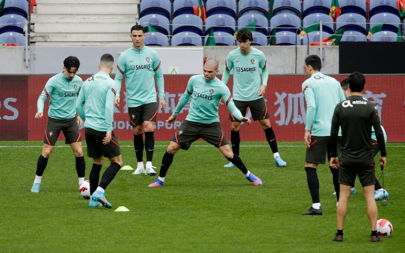 Cristiano Ronaldo and the Portugal squad warm up at training. Reuters