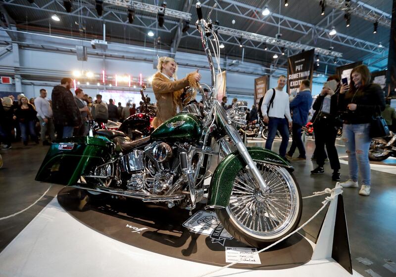 epa07518174 People look over a Harley-Davidson motorcycle on display at the 10th St. Petersburg International Motorcycle Show IMIS 2019 in 'Lenexpo' in St. Petersburg, Russia, 20 April 2019. The Exhibition presents the world's leading brands of motorcycle manufacturers from the USA, Europe, Asia and Russia, famous custom-ateliers, accessories and special equipment, components and spare parts, oils and lubricants, souvenirs and biker attributes.  EPA/ANATOLY MALTSEV