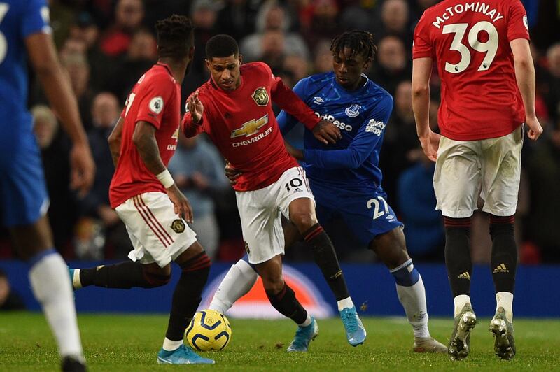 Manchester United striker Marcus Rashford (C) takes on Everton's Italian midfielder Moise Kean. AFP