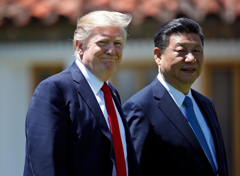 FILE - In this April 7, 2017, file photo President Donald Trump and Chinese President Xi Jinping walk together after their meetings at Mar-a-Lago in Palm Beach, Fla. The White House is suddenly engaged in a multipronged pressure campaign against Beijing, borne of frustration with the limited results of their much-touted cooperation on ending North Korea��������s nuclear threat. On June 29, the Trump administration approved a $1.4 billion arms sale to Taiwan and blacklisted a small Chinese bank over its business ties with North Korea. (AP Photo/Alex Brandon, File)