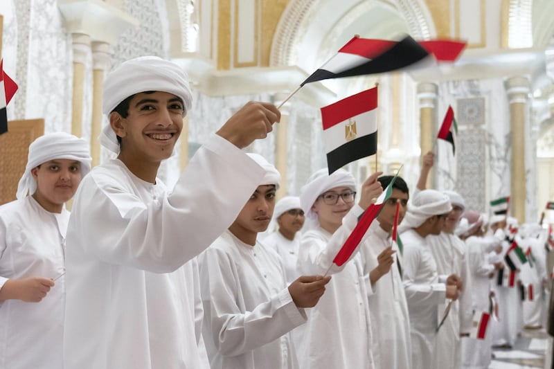 ABU DHABI, UNITED ARAB EMIRATES - November 14, 2019: School children participate in an Egyptian state visit reception, at Qasr Al Watan. Seen with HH Sheikh Rashid bin Hamdan bin Zayed Al Nahyan (L).

( Mohamed Al Hammadi / Ministry of Presidential Affairs )
---