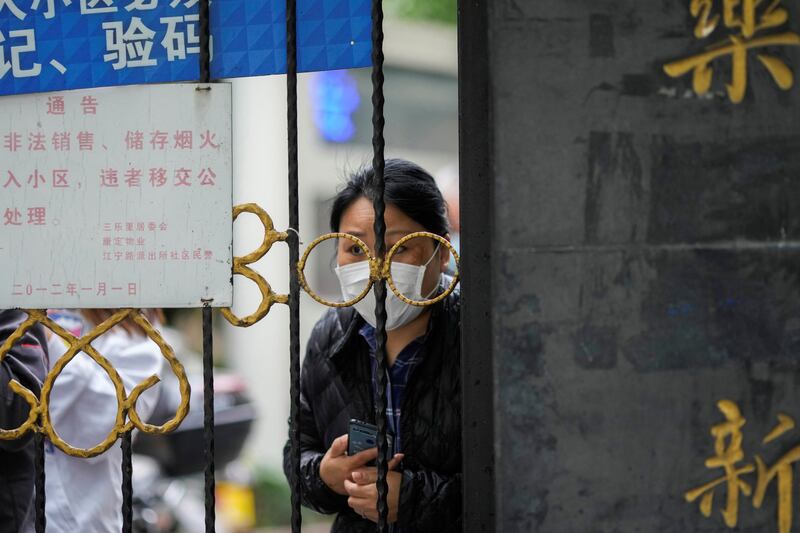 A Shanghai resident waits for delivery of food. Reuters