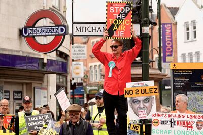 Demonstrators protest against expanding London's Ulez, in which drivers of the most polluting cars pay £12.50 a day to drive, Reuters