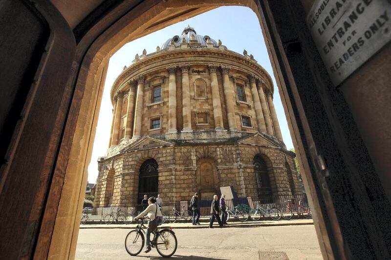 OXFORD, ENGLAND - OCTOBER 08: A cyclist travels past the Radcliffe Camera building in Oxford city centre as Oxford University commences its academic year on October 8, 2009 in Oxford, England. Oxford University has a student population in excess of 20,000 taken from over 140 countries around the world. The University is made up of 38 independent, self-governing colleges, three of which: University College, Balliol College, and Merton College, were established by the 13th century. According to the QS/Times Higher Education rankings, Oxford has slipped down the international league table from fourth to a joint fifth place with Imperial College London.  (Photo by Oli Scarff/Getty Images)