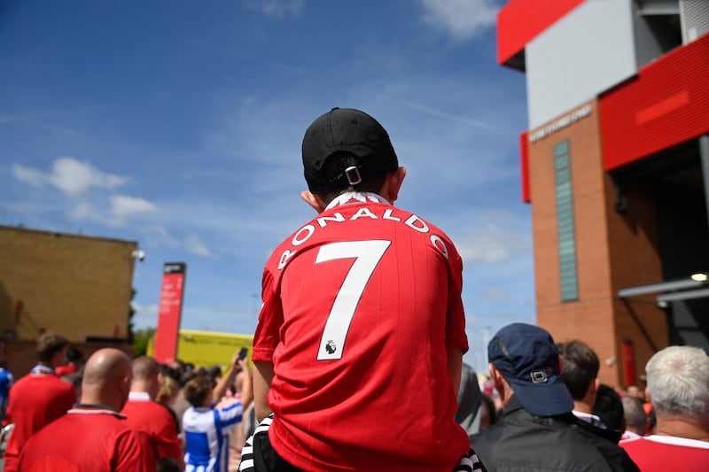A young Manchester United fan wears a Cristiano Ronaldo ahead of the match against Brighton. Reuters
