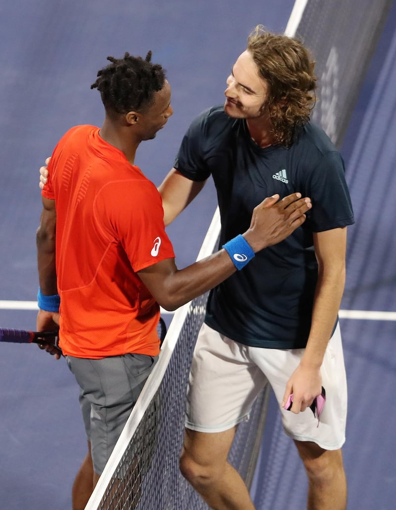 Tsitsipas and Monfils chat at the net after the match. Reuters