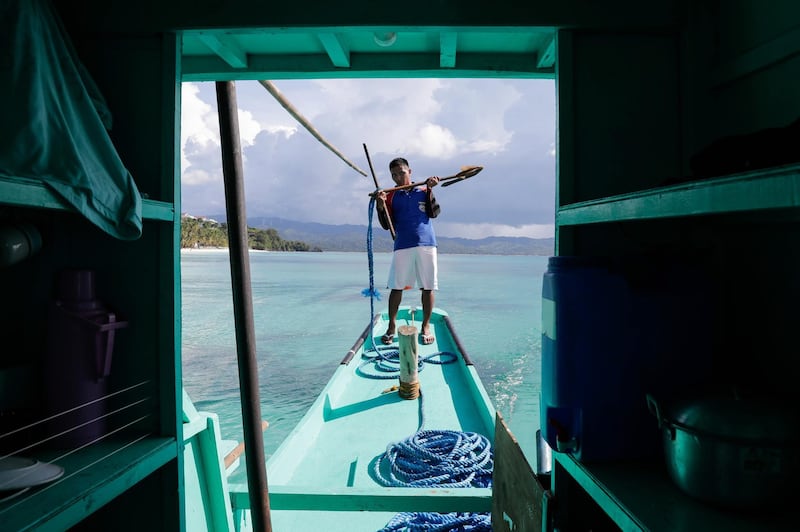 A boatman prepares to anchor a passenger boat in Station 3 on the island of Boracay, Philippines. EPA