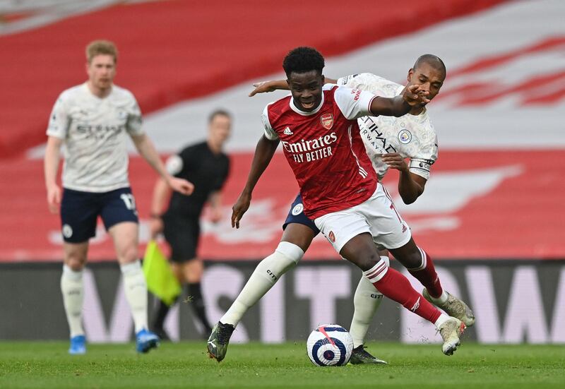 Arsenal attacker Bukayo Saka under pressure from City's Fernandinho. AFP
