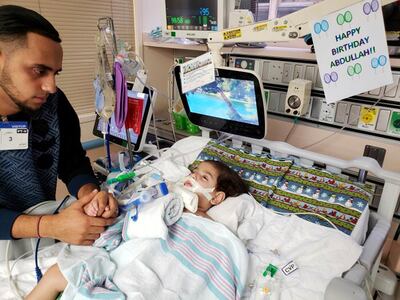 This recent but undated photo, released Monday, Dec. 17, 2018 by the Council on American-Islamic Relations in Sacramento, Calif., shows Ali Hassan with his dying 2-year-old son Abdullah in a Sacramento hospital. The boy's Yemeni mother, blocked by the Trump administration's travel ban, has won her fight for a waiver that would allow her to travel to California to see her son. Basim Elkarra of the Council on American-Islamic Relations in Sacramento said Shaima Swileh was granted a visa Tuesday, Dec. 18, 2018, and will be flying to San Francisco on Wednesday, Dec. 19, 2018. (Council on American-Islamic Relations via AP)