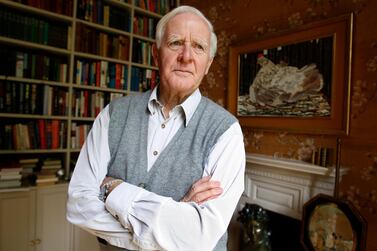 FILE - In this Aug. 28, 2008 file photo Author John Le Carre poses for a photo at his home in London. John le Carre, the spy-turned-novelist whose elegant and intricate narratives defined the Cold War espionage thriller and brought acclaim to a genre critics had once ignored, has died. He was 89, Le Carre's literary agency, Curtis Brown, said Sunday, Dec. 13, 2020 that he died in Cornwall, southwest England on Saturday. (AP Photo/Kirsty Wigglesworth, File)