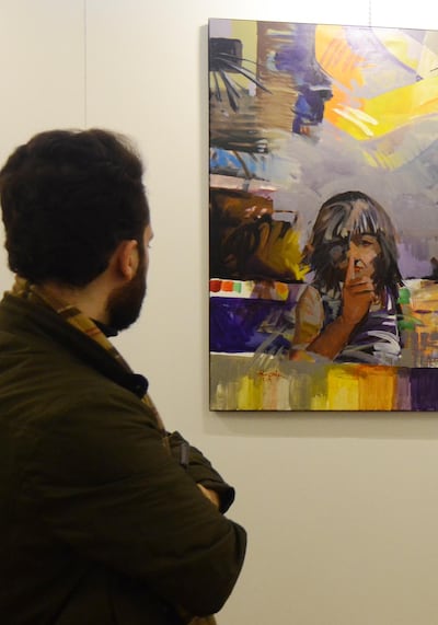 An Iraqi man looks on January 29, 2019 at a painting displayed at a contemporary art exhibition hall in the museum of the northern Iraqi city of Mosul, which served as the Islamic State (IS) group's brutal seat of power for three years, before Iraqi troops recaptured it in 2017. Mosul's celebrated museum has not recovered since IS jihadists ravaged its ancient treasures several years ago, but part of the complex reopened today to showcase more modern art. For the first time since IS overran the Iraqi city in 2014, visitors on could wander the grandiose royal reception hall, which formed part of the museum. / AFP / Zaid AL-OBEIDI
