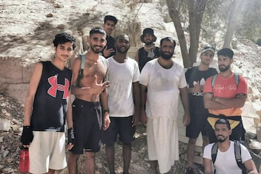 Youssef Al Habsi, centre, dressed all in white, with the eight hikers he rescued. Ras Al Khaimah Civil Defence