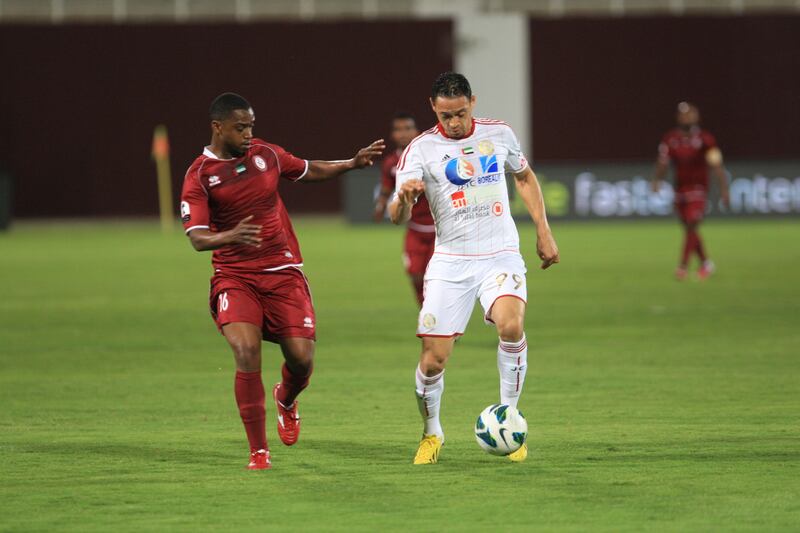 Al Jazira's Ricardo de Oliveira dribbles the ball through Al Wahda defenders during the semi-Final Pro League football match between Al Wahda v Al Jazira (white) at Al Wahda's (red) at Al Nahyan Stadium in Abu Dhabi on Monday March 25, 2013. (Ravindranath K / The National)?