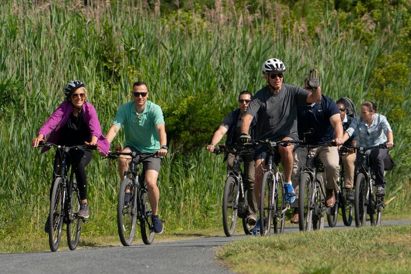 President Joe Biden and first lady Jill Biden ride their bikes on a trail at Gordons Pond in Rehoboth Beach, Delaware. AP