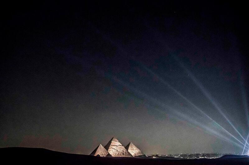 A general view of (R to L) the Great Pyramid of Khufu (Cheops), the Pyramid of Khafre (Chephren), and the Pyramid of Menkaure (Menkheres) at the Giza Pyramids necropolis on the southwestern outskirts of the Egyptian capital Cairo during an official ceremony launching the trial operations of the site's first environmentally-friendly electric bus and restaurant as part of a wider development plan at the necropolis.  AFP