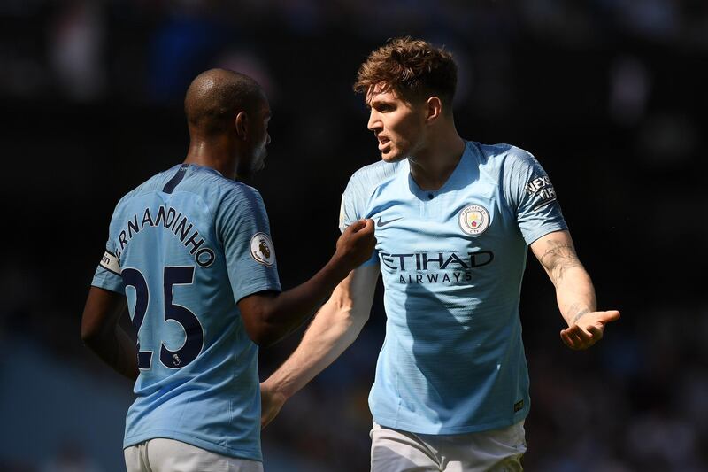 Stones talks to teammate Fernandinho during the match. Getty Images