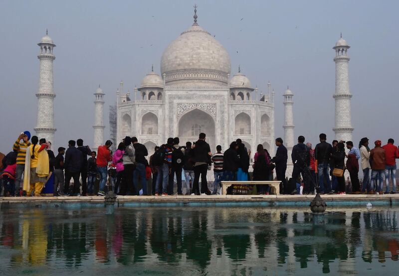 (FILES) In this file photo taken on January 03, 2018, crowds gather to visit the Taj Mahal in Agra. Authorities have hiked fivefold ticket prices for Indian visitors to the Taj Mahal in the latest attempt to reduce visitor numbers to the country's top tourist site and reduce damage. / AFP / DOMINIQUE FAGET
