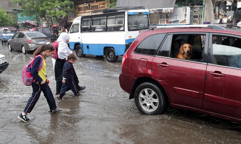 People make their way during rain shower in Cairo, Egypt. According to reports, showers are hitting Cairo as temperatures reach 21 degrees Celsius.  EPA