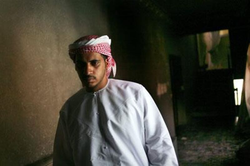 Ahmed al Kalbani looks over the remnants of his brother Mohamed's house, where his sister-in-law and her two children died.