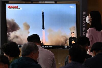 People watch a news broadcast showing footage of a North Korean missile test, at a railway station in Seoul on June 5. AFP
