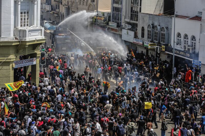 The security forces fire tear gas and use water cannon to disperse an anti-government protest. EPA