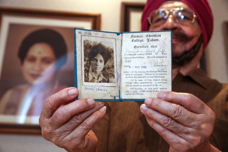 Narindra Singh Pujji shows his college identity card from Forman Christian College – better known as FC College – in Lahore, where he studied before leaving Pakistan for India in 1947. Victor Besa / The National