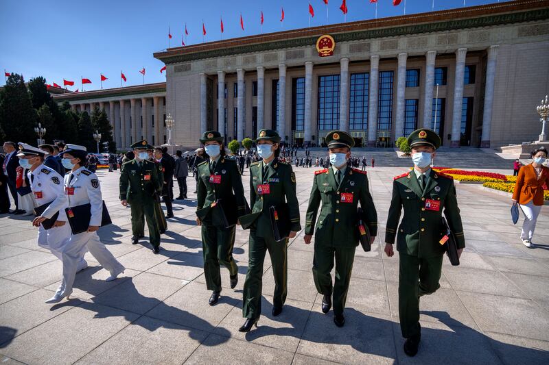 Military attendees leave after the opening ceremony of the 20th National Congress of China's ruling Communist Party at the Great Hall of the People in Beijing. AP Photo