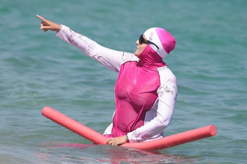 A woman wearing a burqini takes a dip in south of France (Photo by Sipa USA)