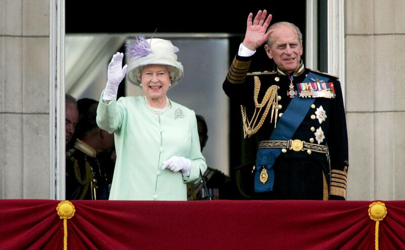 LONDON, UNITED KINGDOM - JULY 10:  HM Queen Elizabeth II, The Queen, and Prince Philip, Duke of Edinburgh, watch the flypast over The Mall of British and US World War II aircraft from the Buckingham Palace balcony on National Commemoration Day July 10, 2005 in London.  Poppies were dropped from the Lancaster Bomber of the Battle Of Britain Memorial Flight as part of the flypast.  (Photo by Daniel Berehulak/Getty Images)
