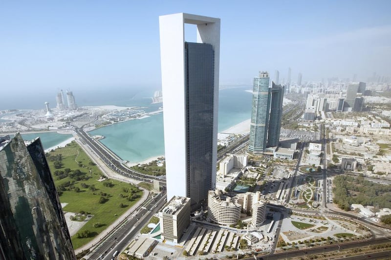 Adnoc would need to find a replacement for the project as energy companies struggle to respond to the collapse of the price of oil. Above, the company headquarters in Abu Dhabi. Christopher Pike / The National